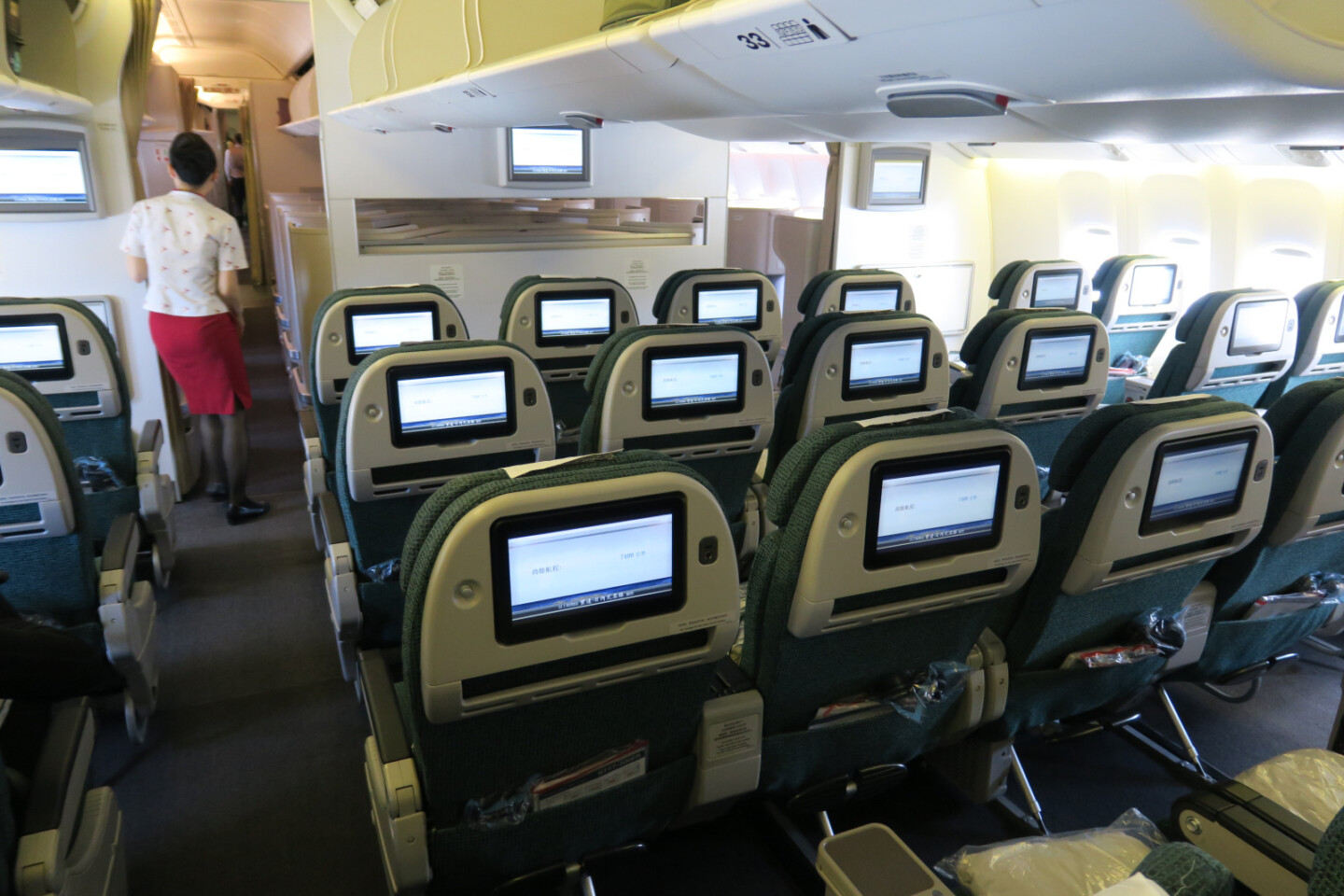 a row of seats with monitors on the back