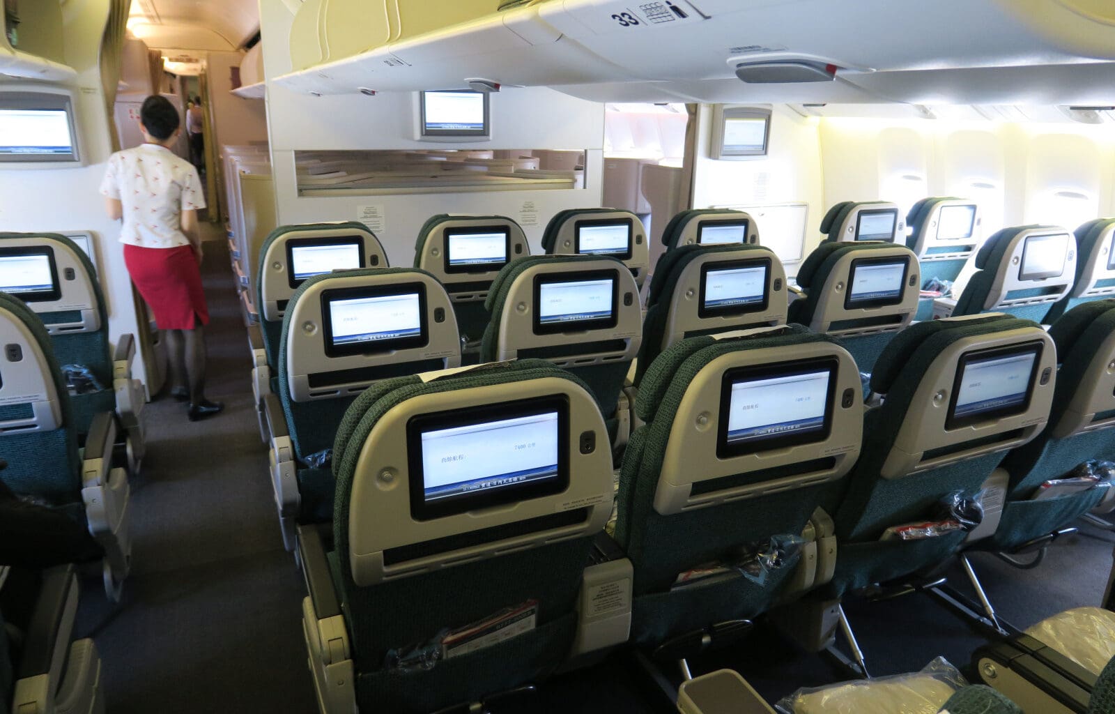 a row of seats with monitors on the back