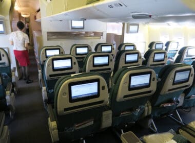 a row of seats with monitors on the back