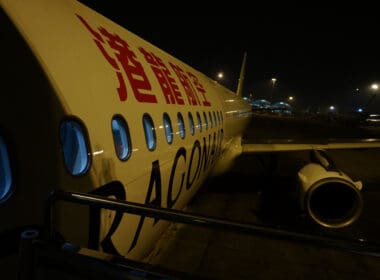 a white airplane with red writing on it