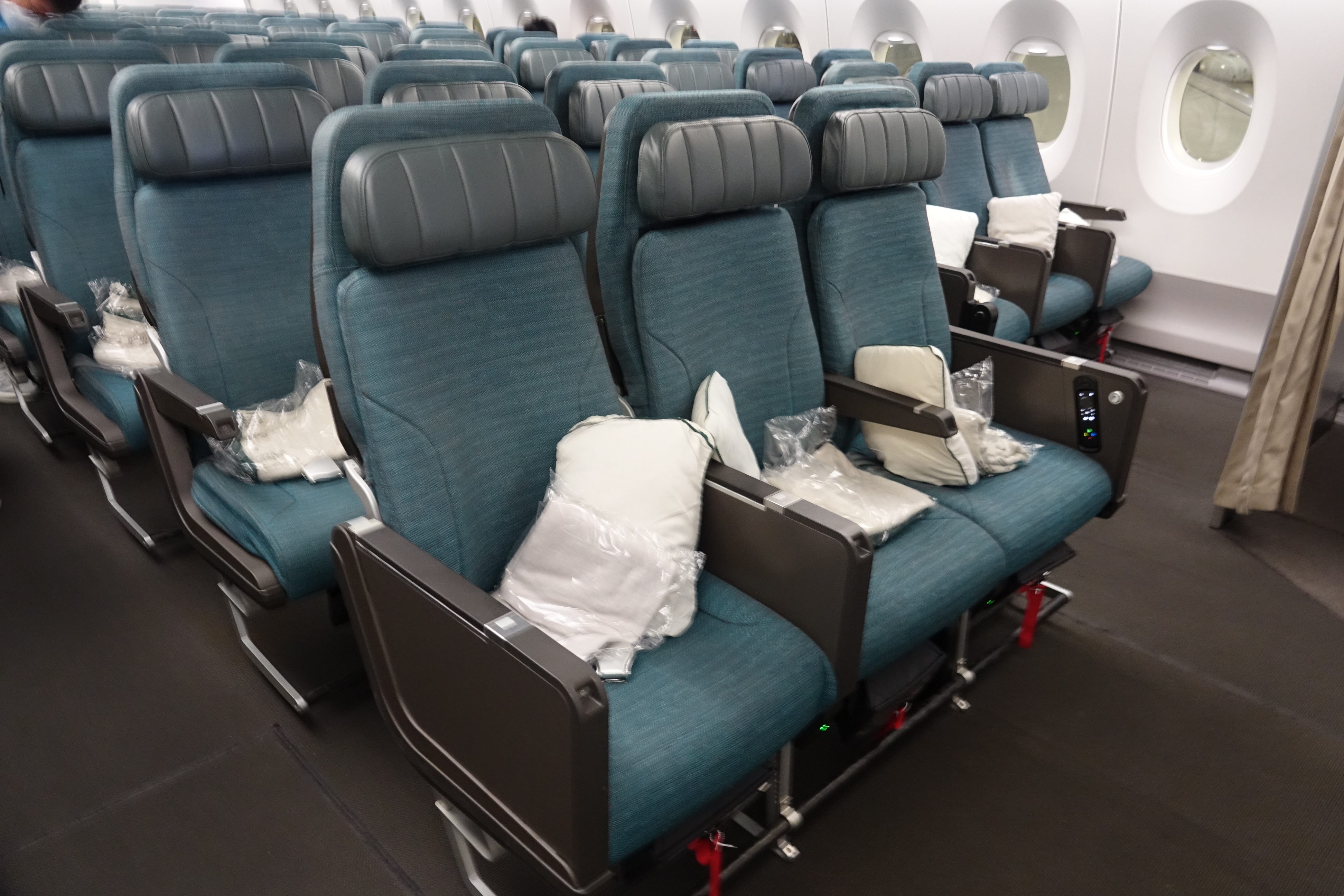 a row of blue seats in an airplane