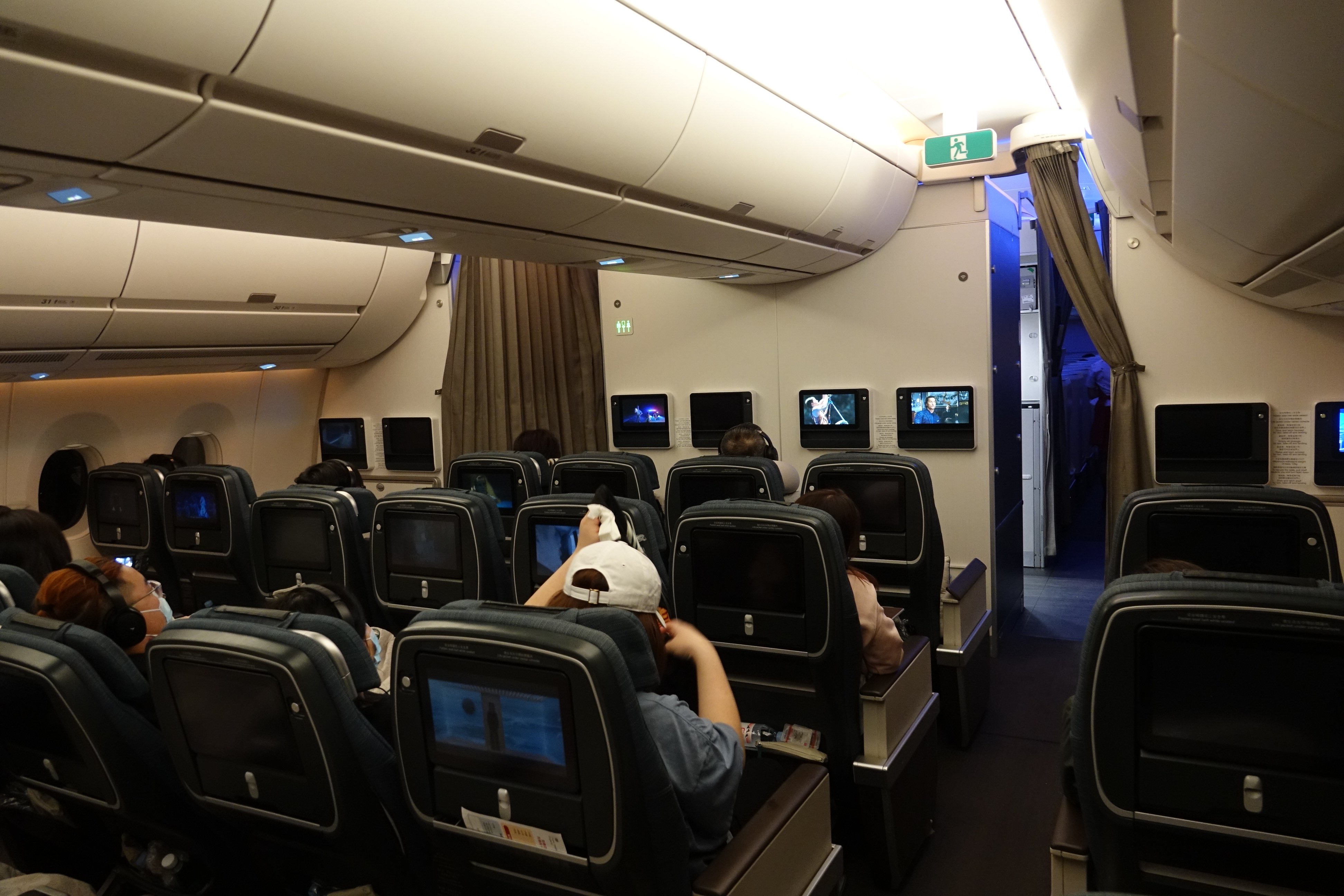 a group of people sitting in chairs in an airplane