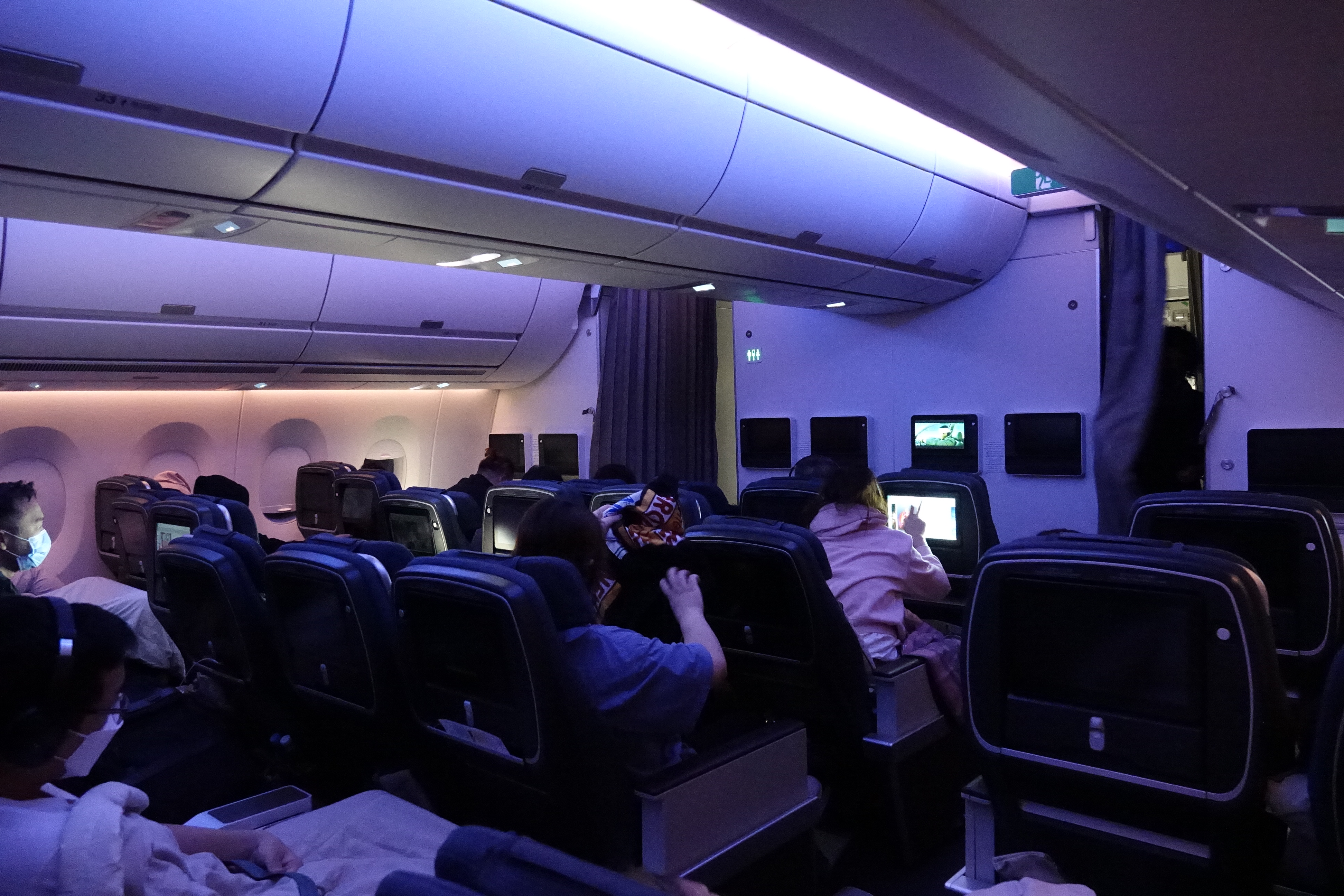 people sitting in an airplane with a few people on the seats