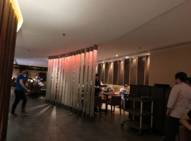 a room with a wall of wood and lights