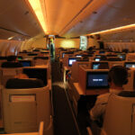 a group of people sitting in chairs in an airplane