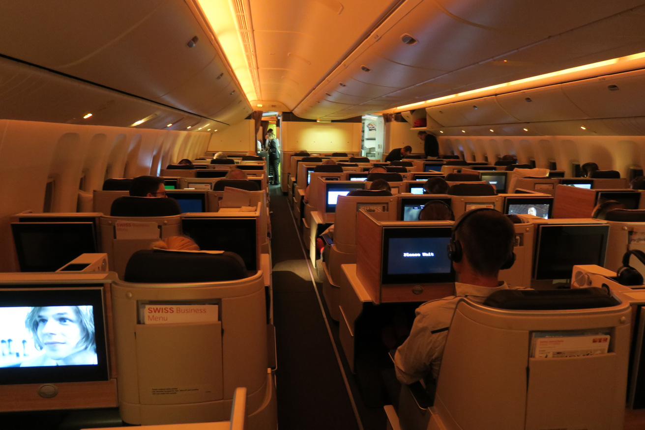 a group of people sitting in chairs in an airplane