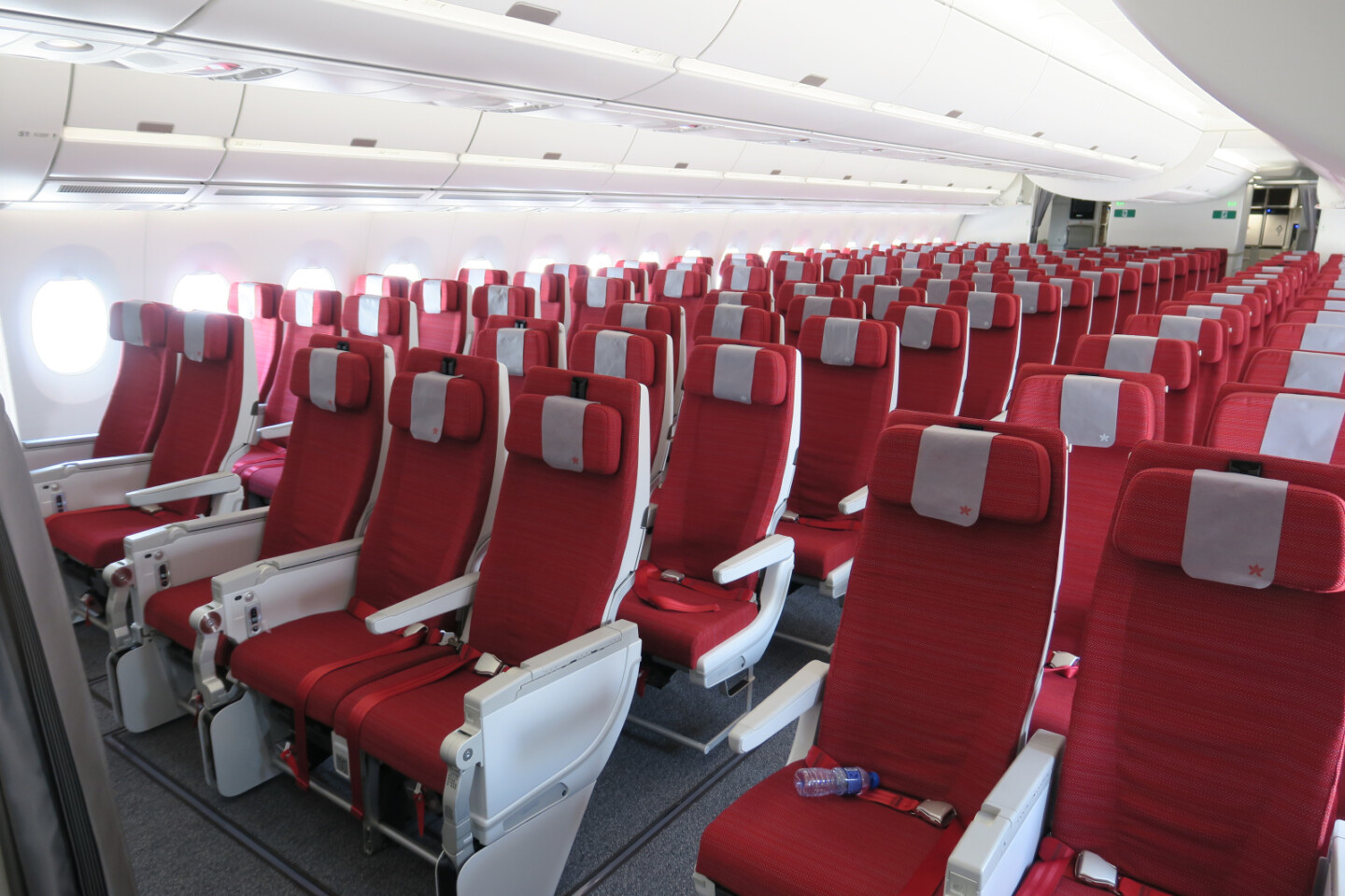 a row of red seats in an airplane