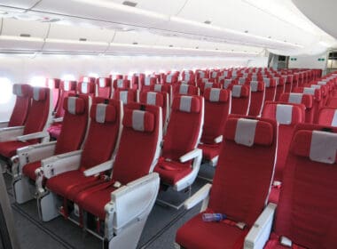 a row of red seats in an airplane