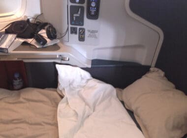 a bed with a pillow and headphones on the side