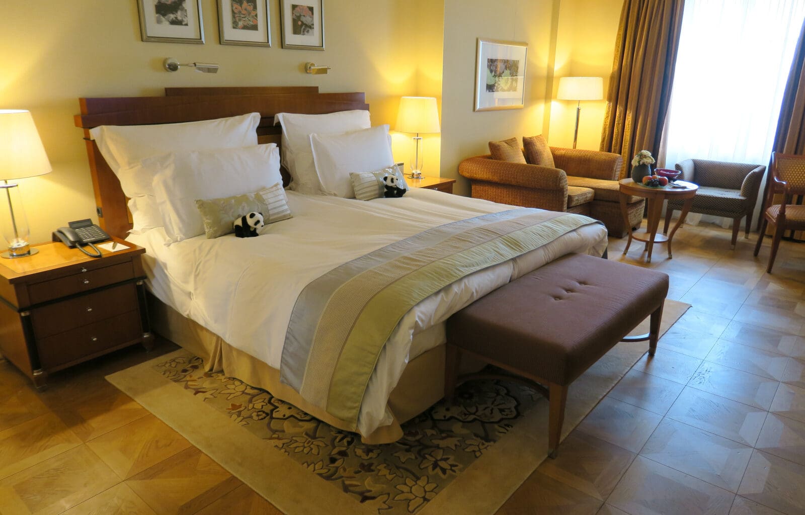 a bed with pillows and a bench in a room