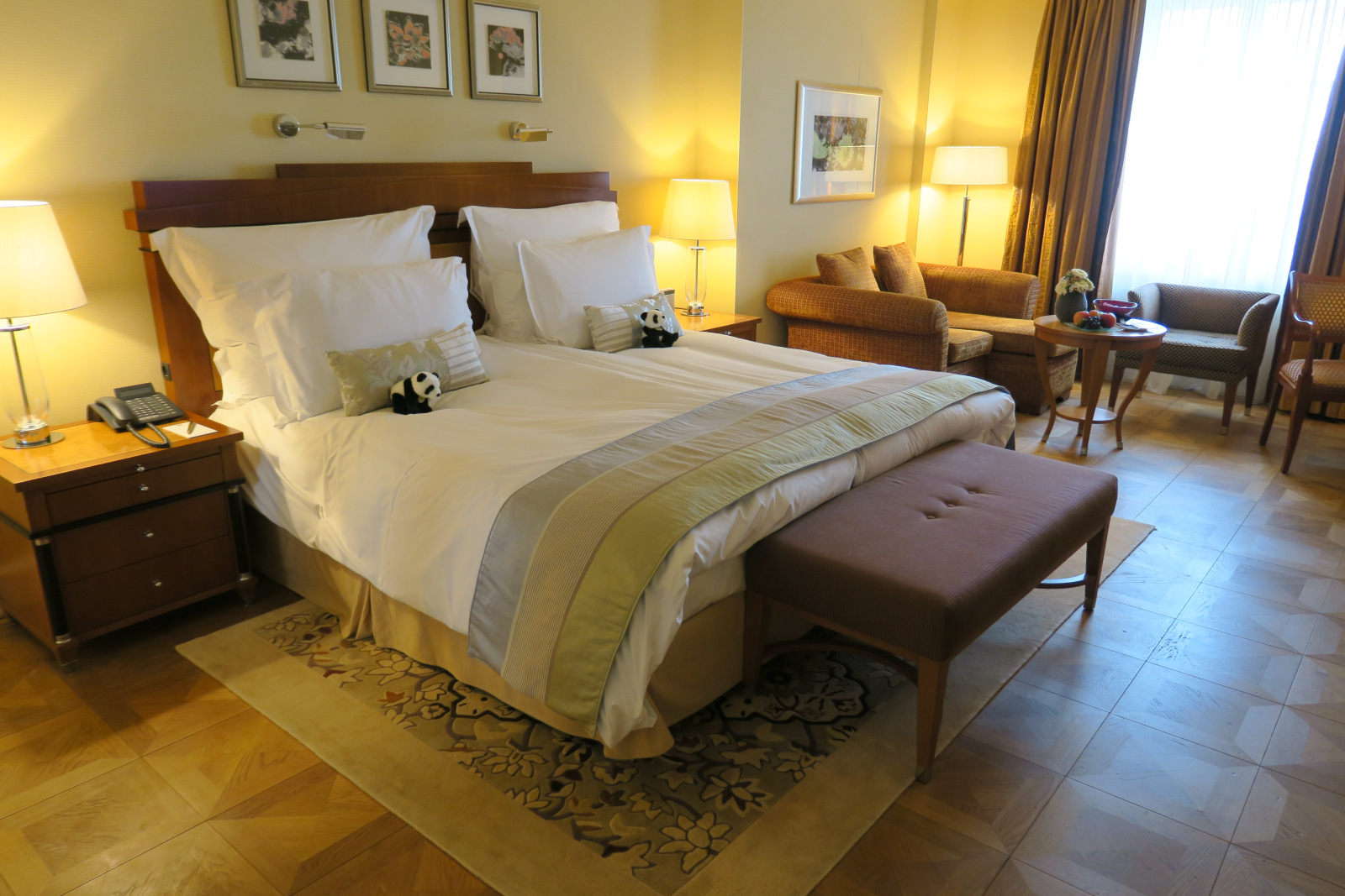 a bed with pillows and a bench in a room