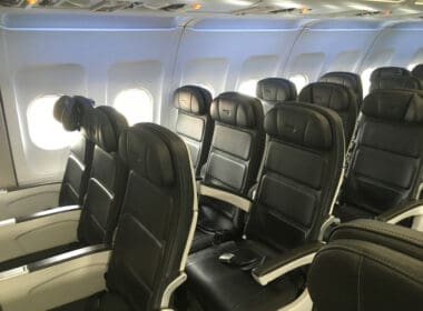 a row of black seats on an airplane