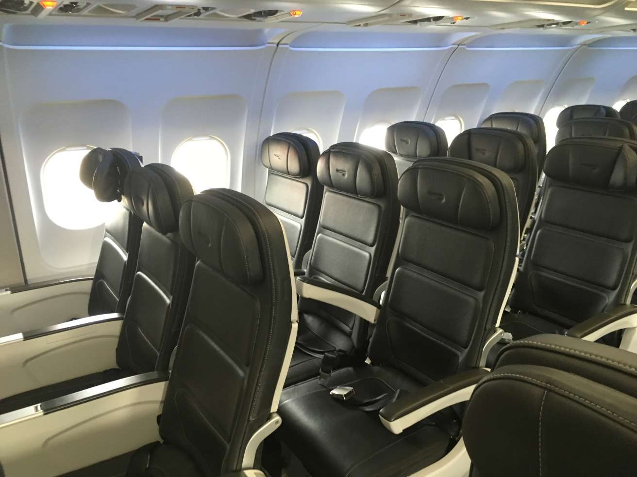 a row of black seats on an airplane