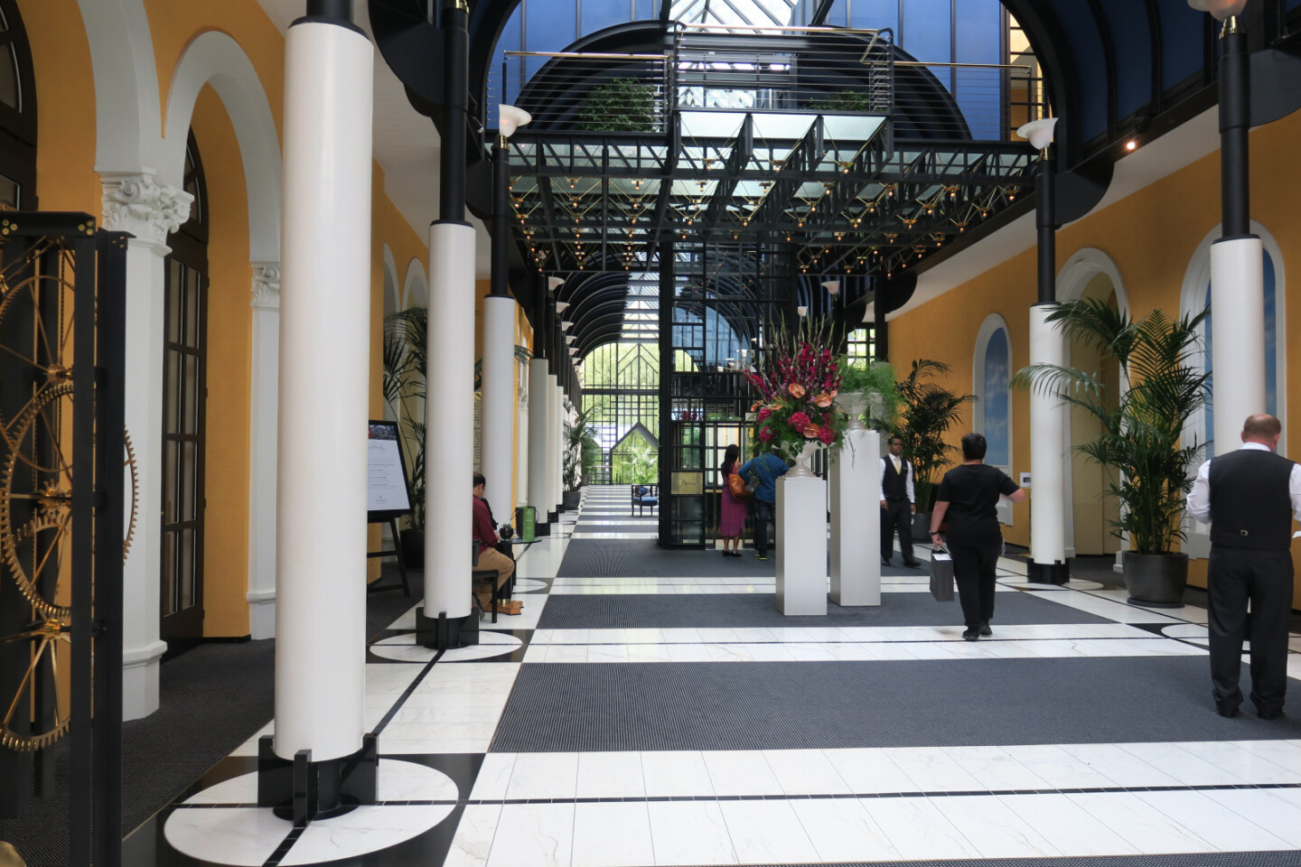 people inside a building with columns and people