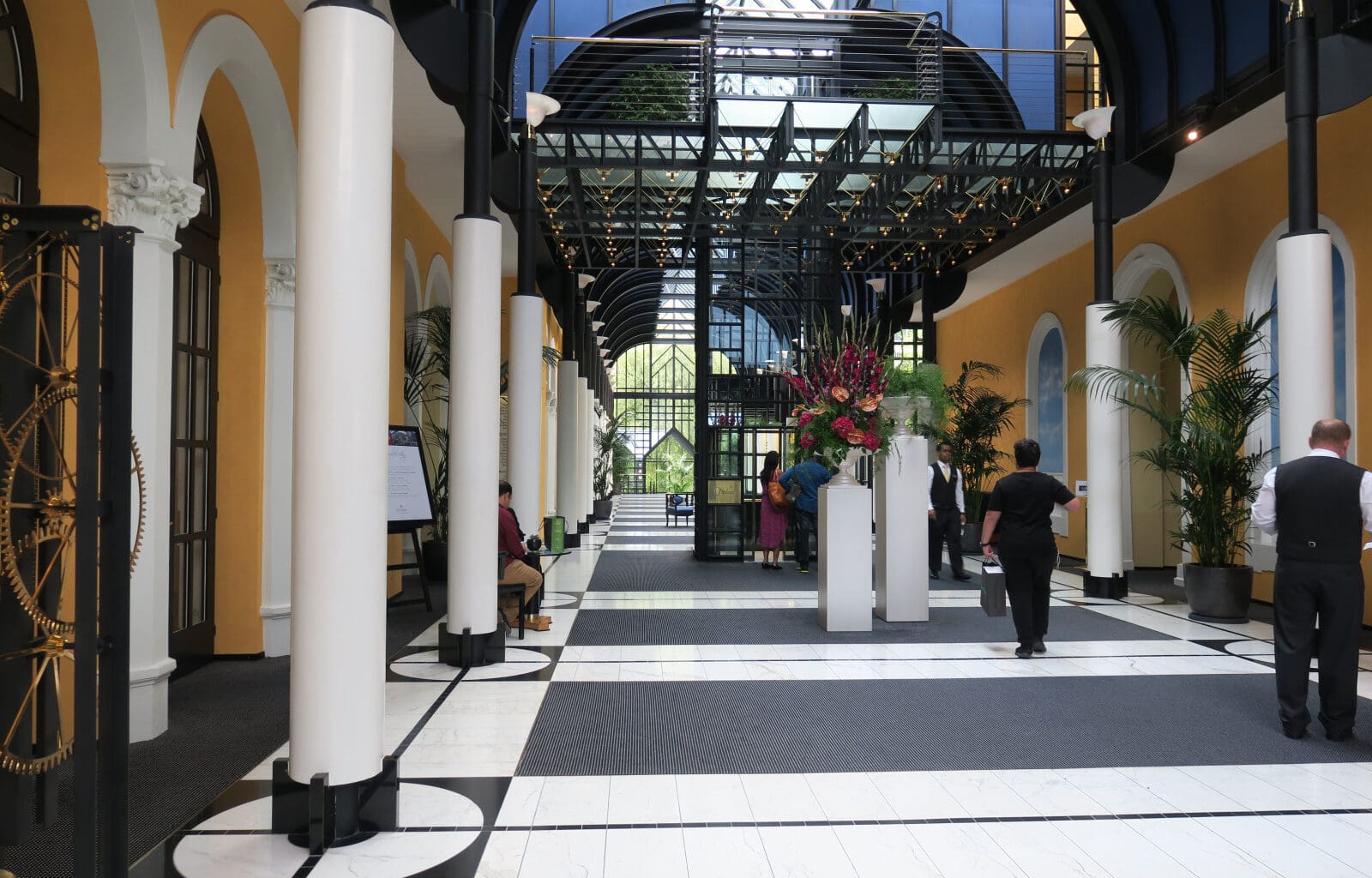 people inside a building with columns and people