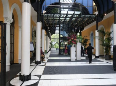 people inside a building with columns and people