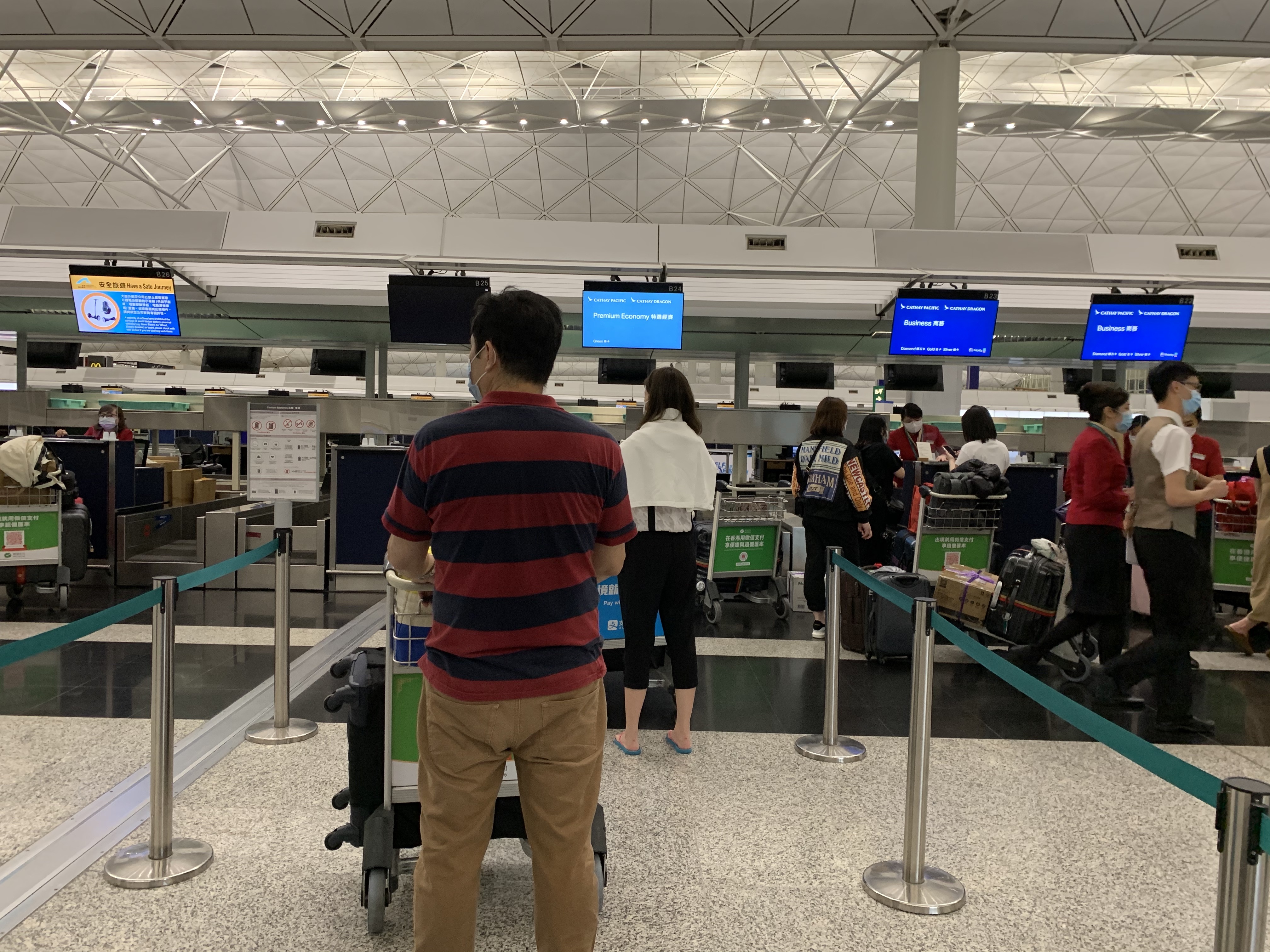 people standing in a line at an airport