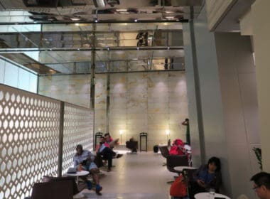 people sitting in a room with a wall and a ceiling