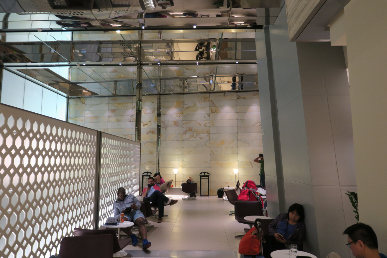 people sitting in a room with a wall and a ceiling