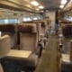 a train with seats and a person standing in the back