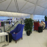 a man sitting in a chair in an airport