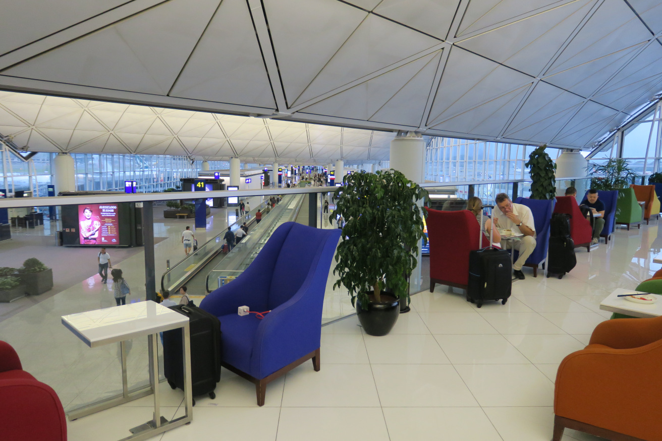 a man sitting in a chair in an airport