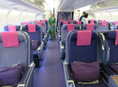 a woman standing in a row of seats