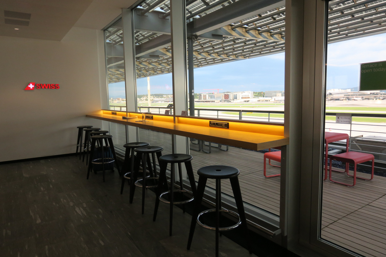 a row of stools in a room with a window