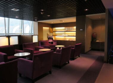 a room with purple chairs and tables