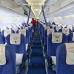 a row of blue seats on an airplane