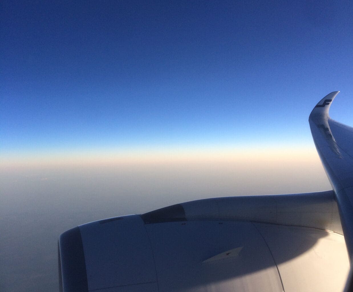 an airplane wing and blue sky