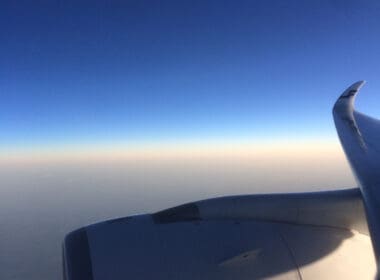 an airplane wing and blue sky