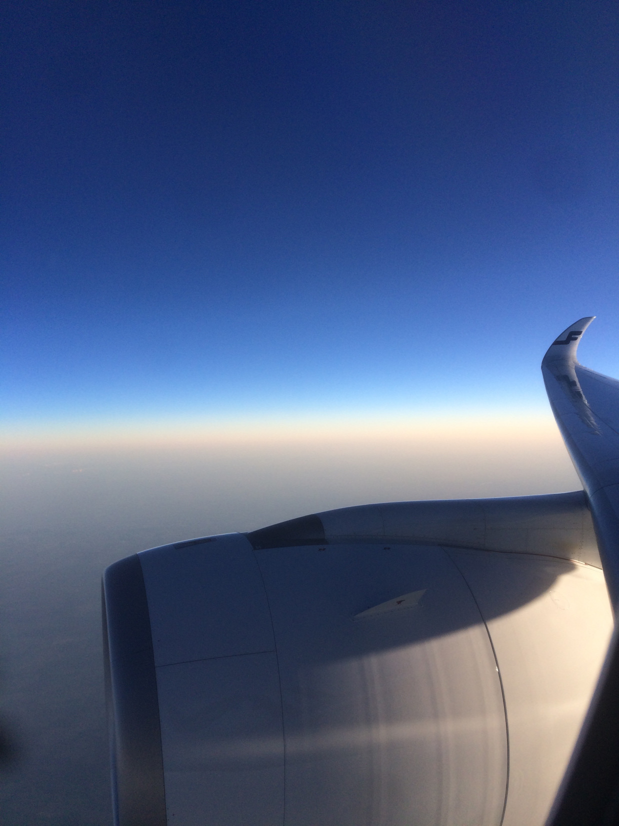 an airplane wing and blue sky