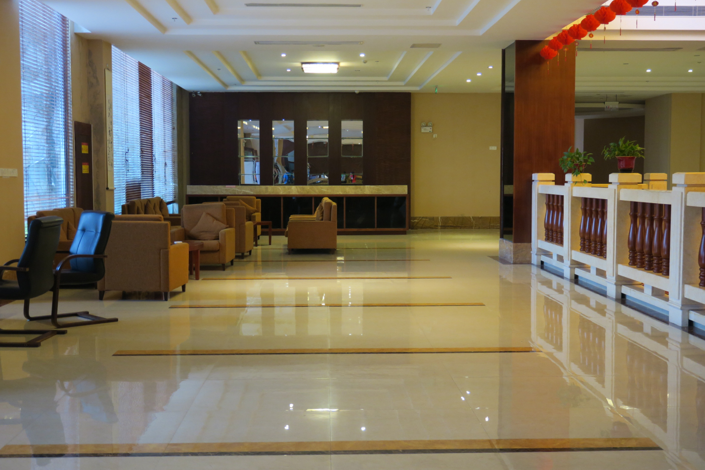 a lobby with chairs and a mirror