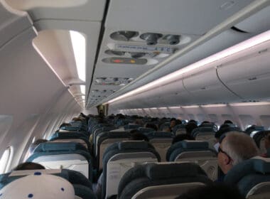 a plane with many seats and a few people