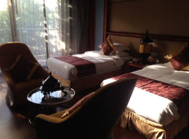 a room with two beds and a table