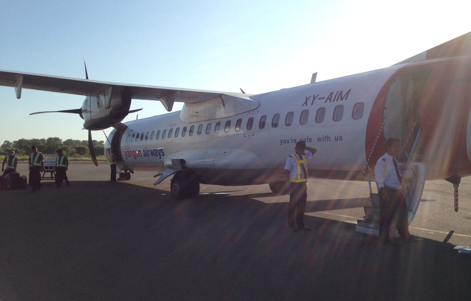 a group of people standing next to an airplane