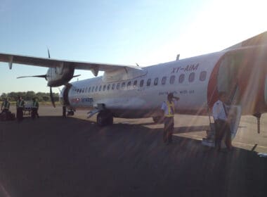 a group of people standing next to an airplane