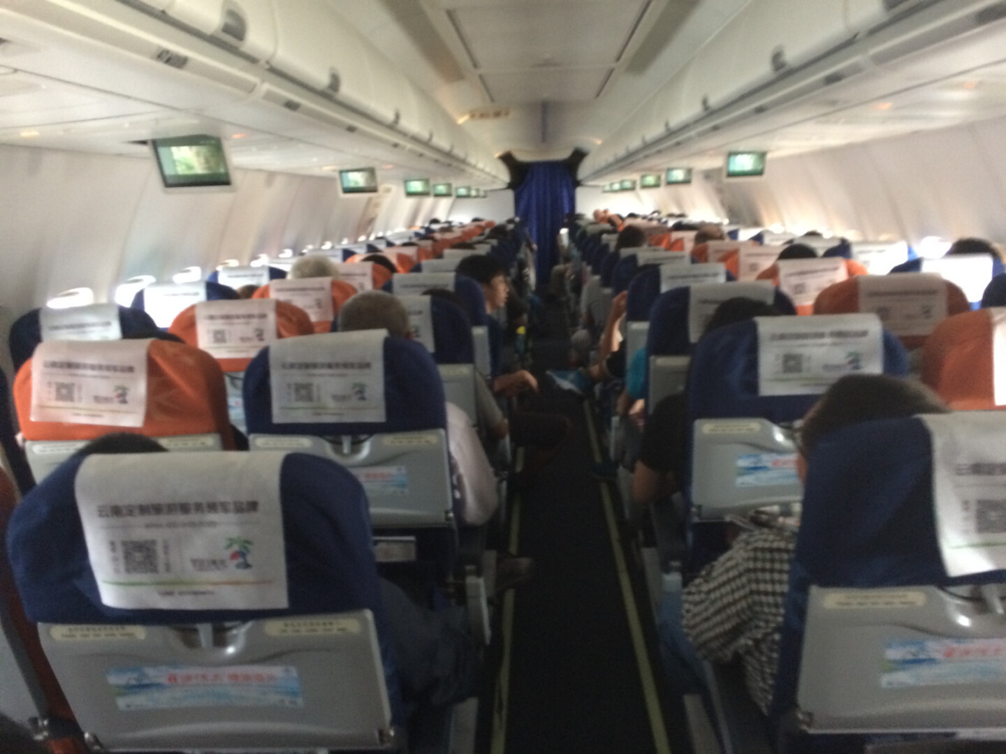 a group of people sitting in an airplane