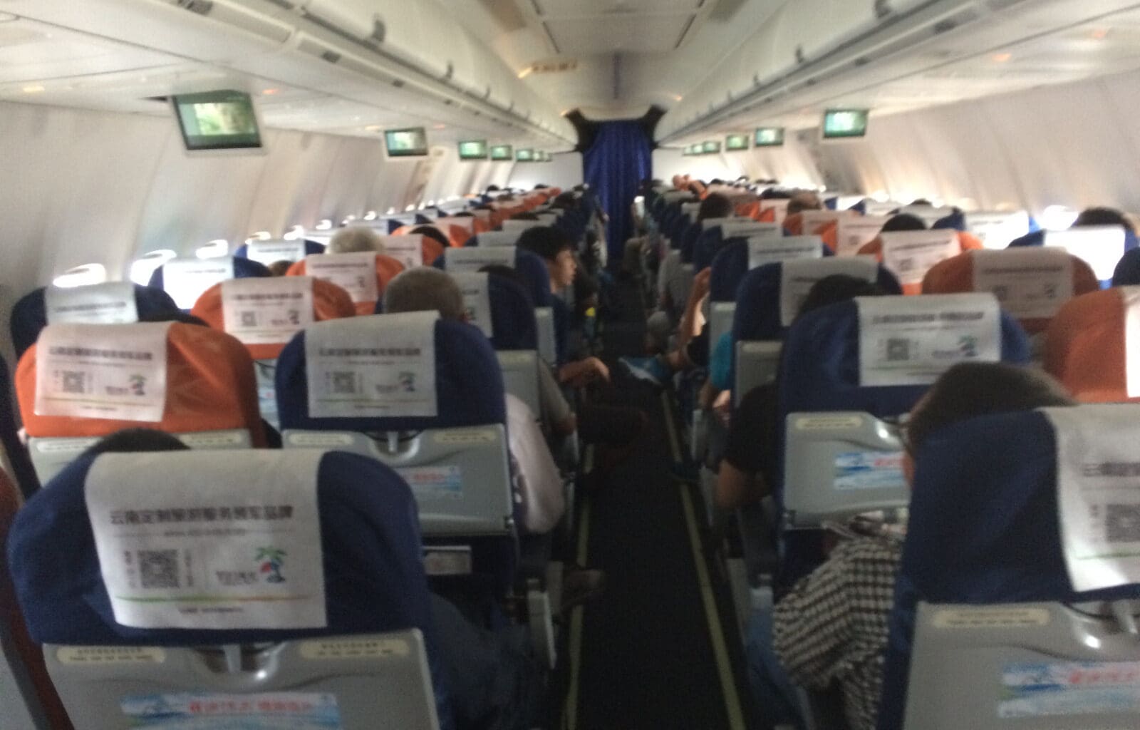 a group of people sitting in an airplane