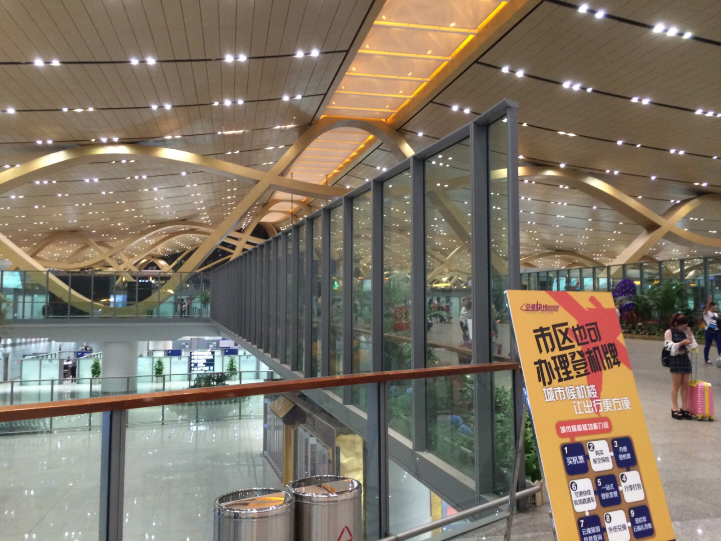 a glass wall with a sign in the middle of a building