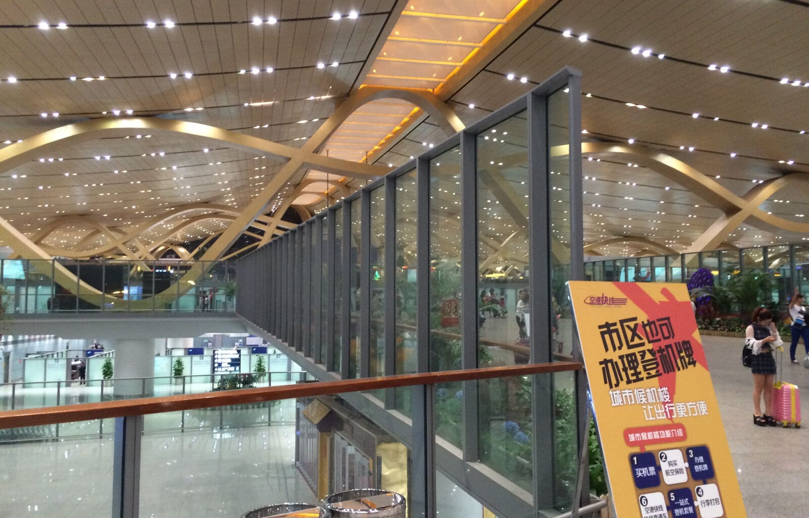 a glass wall with a sign in the middle of a building