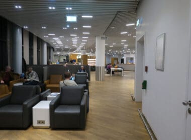 people sitting in a room with chairs and tables