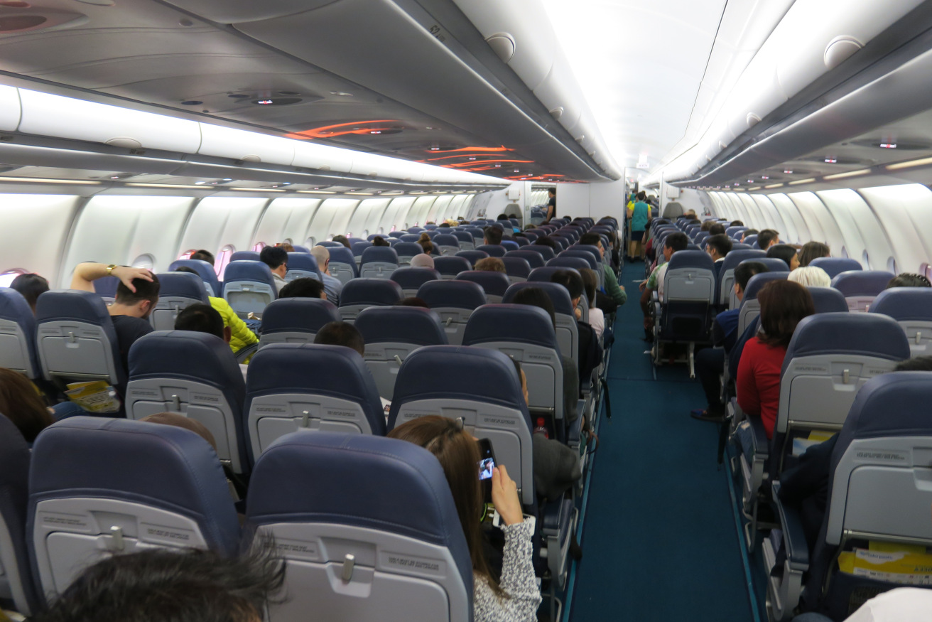 a group of people sitting in an airplane