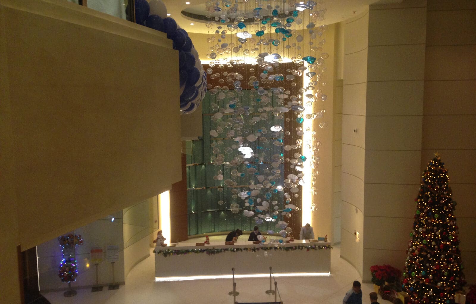 a lobby with a large chandelier and balloons