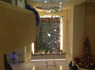 a lobby with a large chandelier and balloons