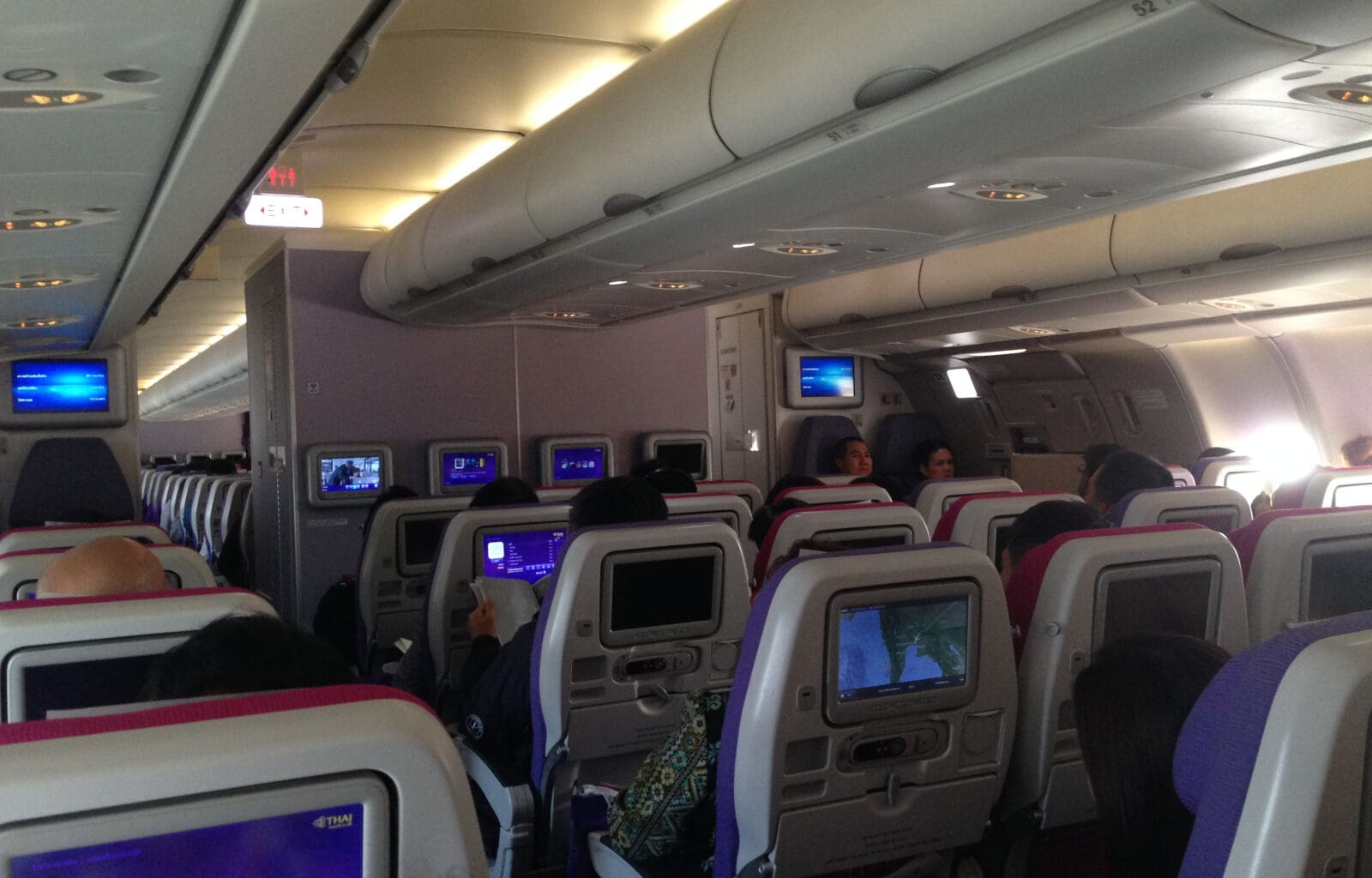 a group of people sitting in an airplane