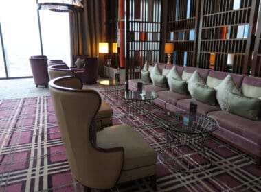 a room with a couch and chairs