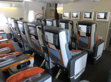 a row of seats with screens on the back