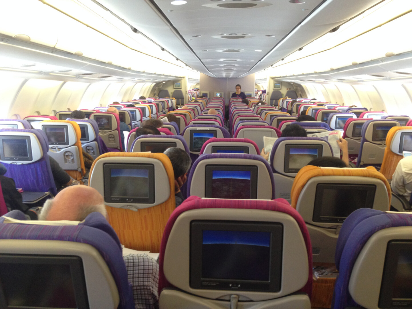 a group of people sitting in an airplane